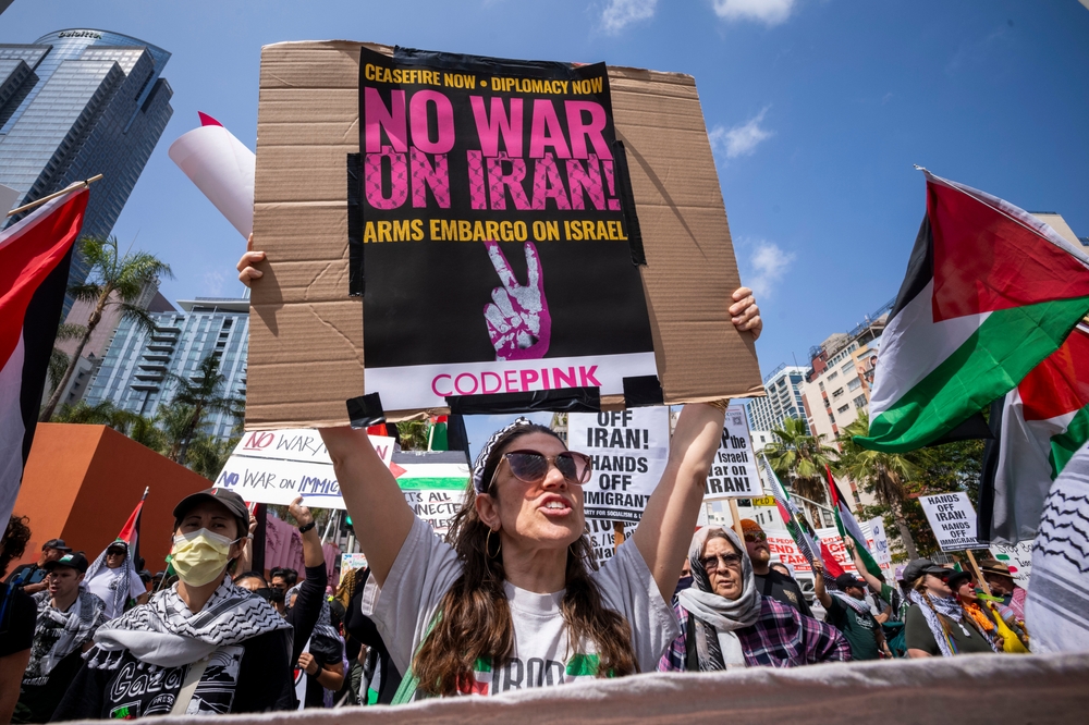 A demonstrator in Los Angeles holds a sign reading "No War on Iran" (Shutterstock)